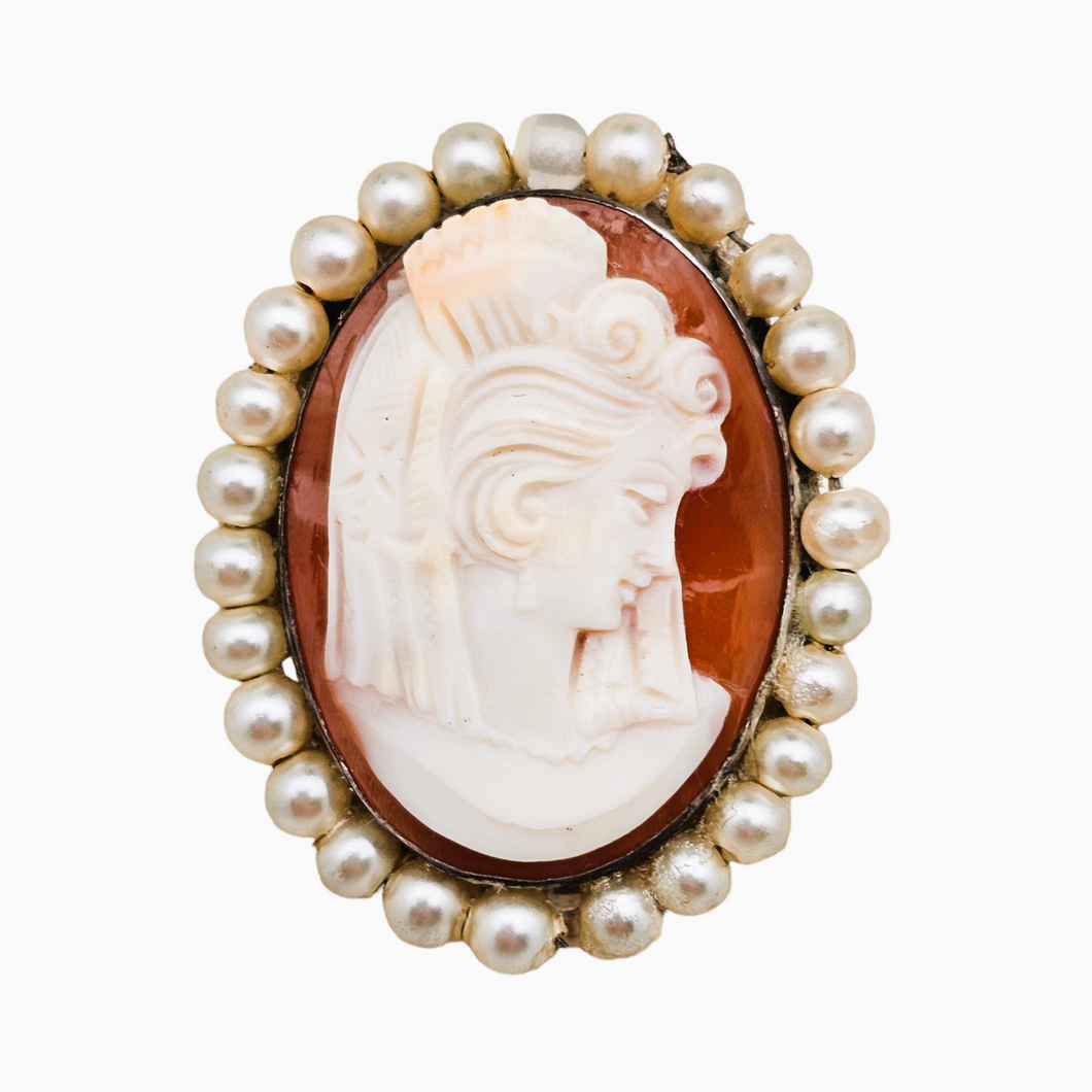 Shell cameo pendant brooch surrounded by pearls representing a young woman in an 800 silver setting, early 20th century